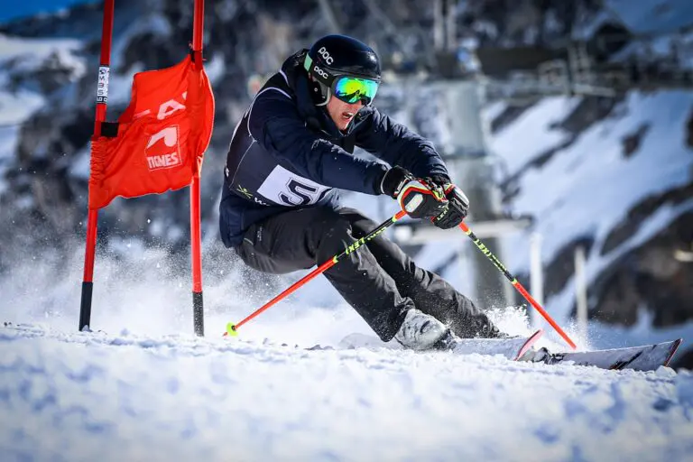 skier racing downhill through slalom gates in Tignes