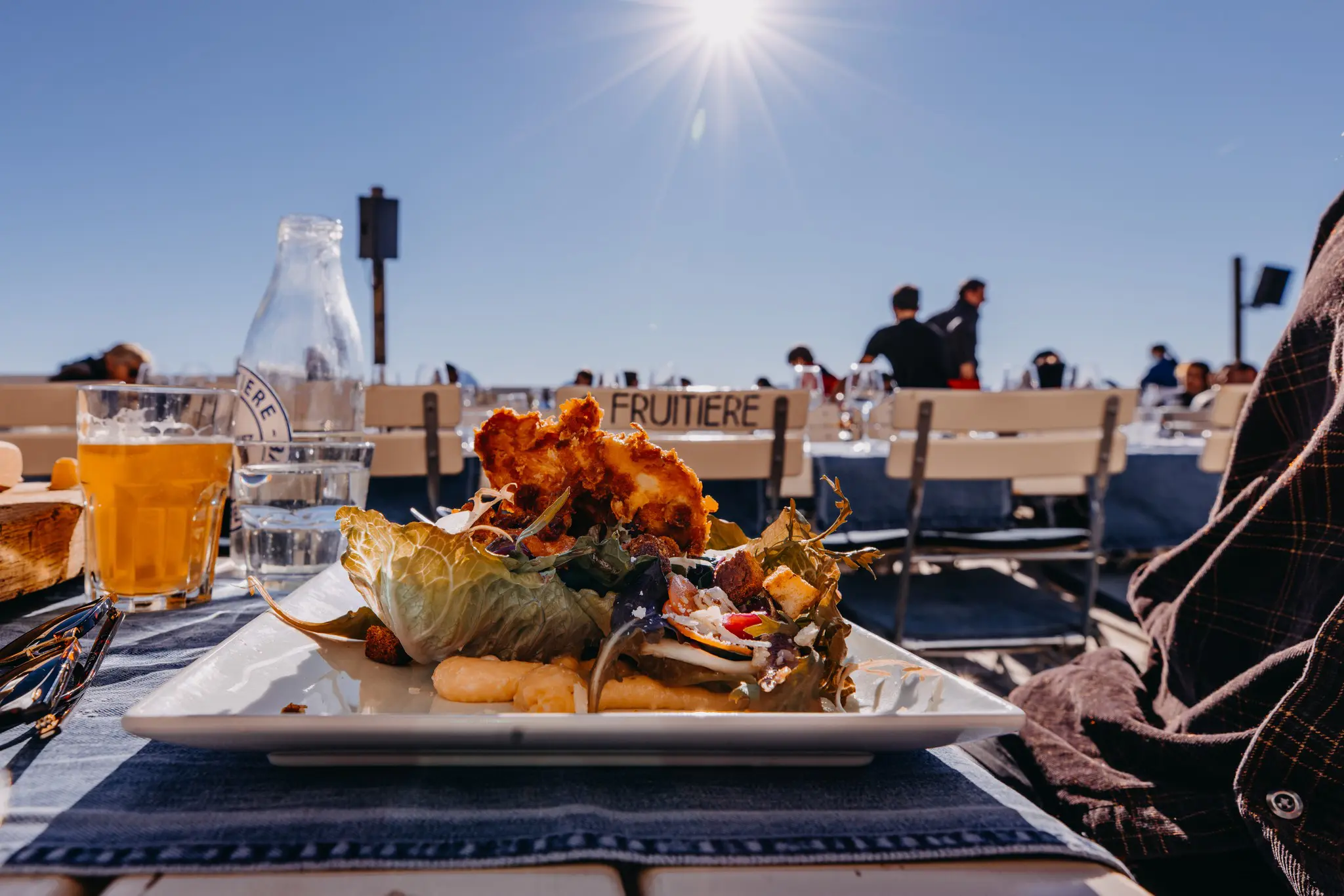 lunch on a sunny mountain terrace with fried chicken salad